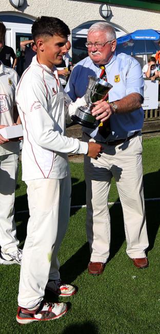 Iori Hicks receives the trophy from Gethin Evans